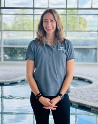 a woman standing in front of a pool